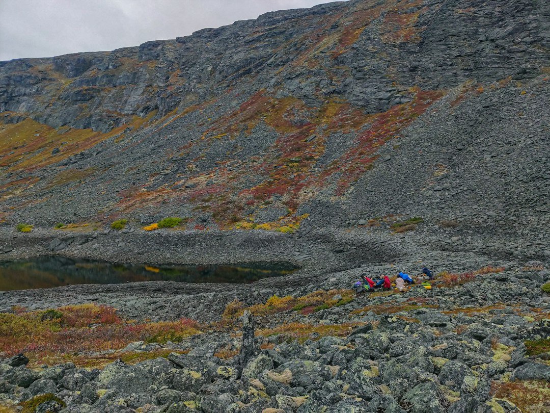 Campground in a rocky mountain valley with autumn foliage