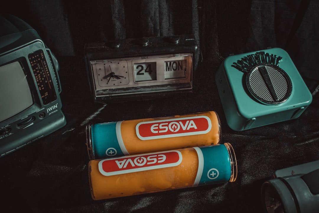 orange and blue battery on black surface