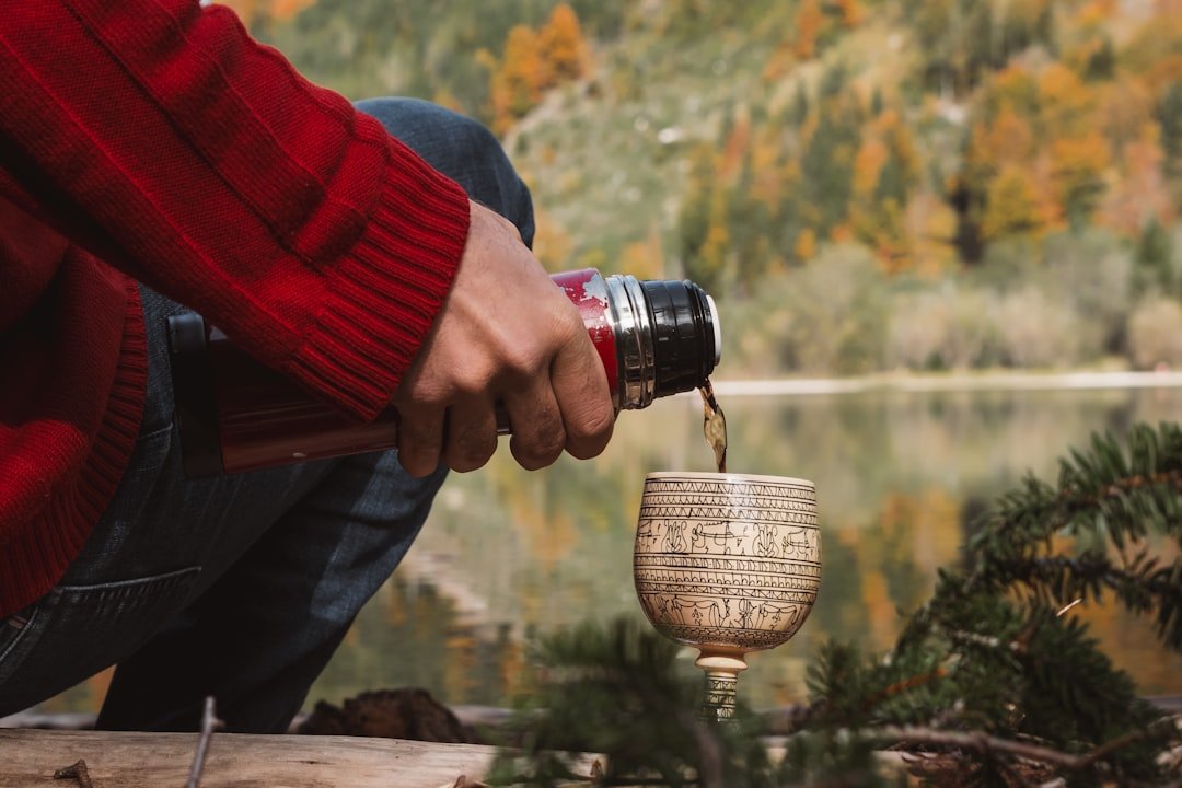 A person is pouring water into a cup