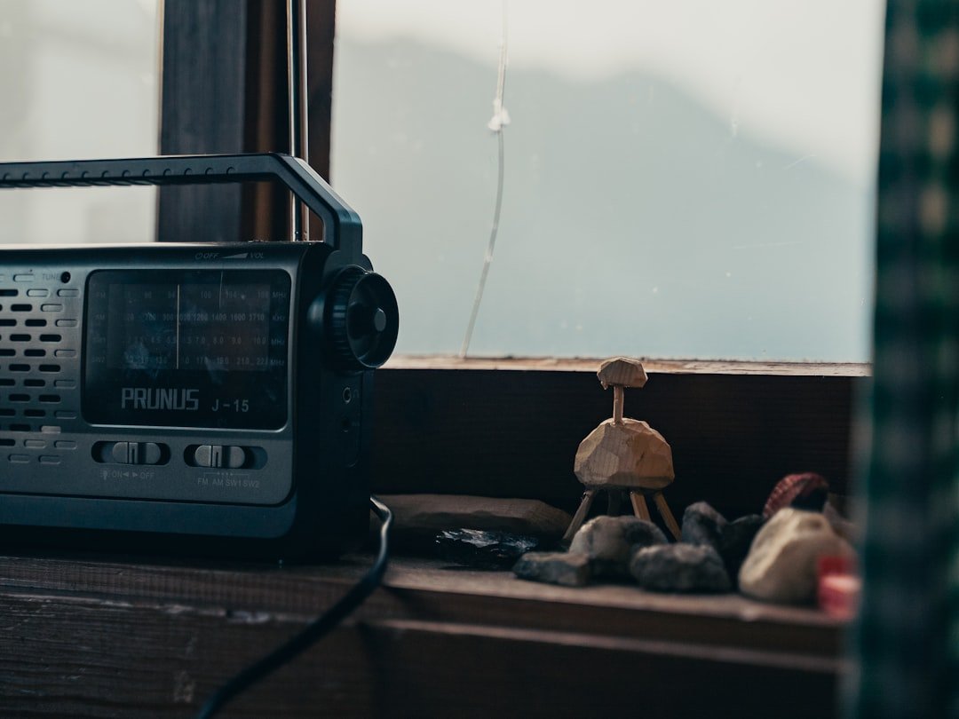 A radio sitting on top of a window sill