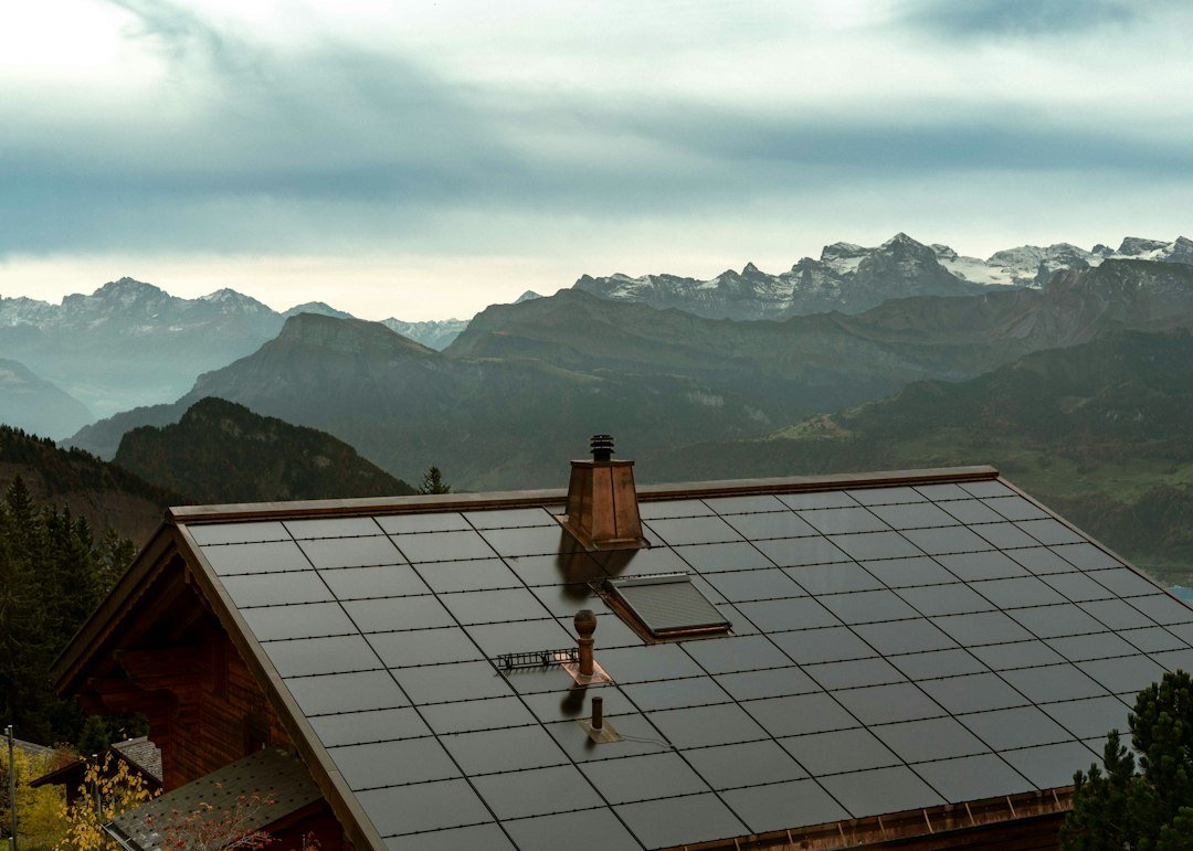 Solar panels cover the roof of a mountain cabin
