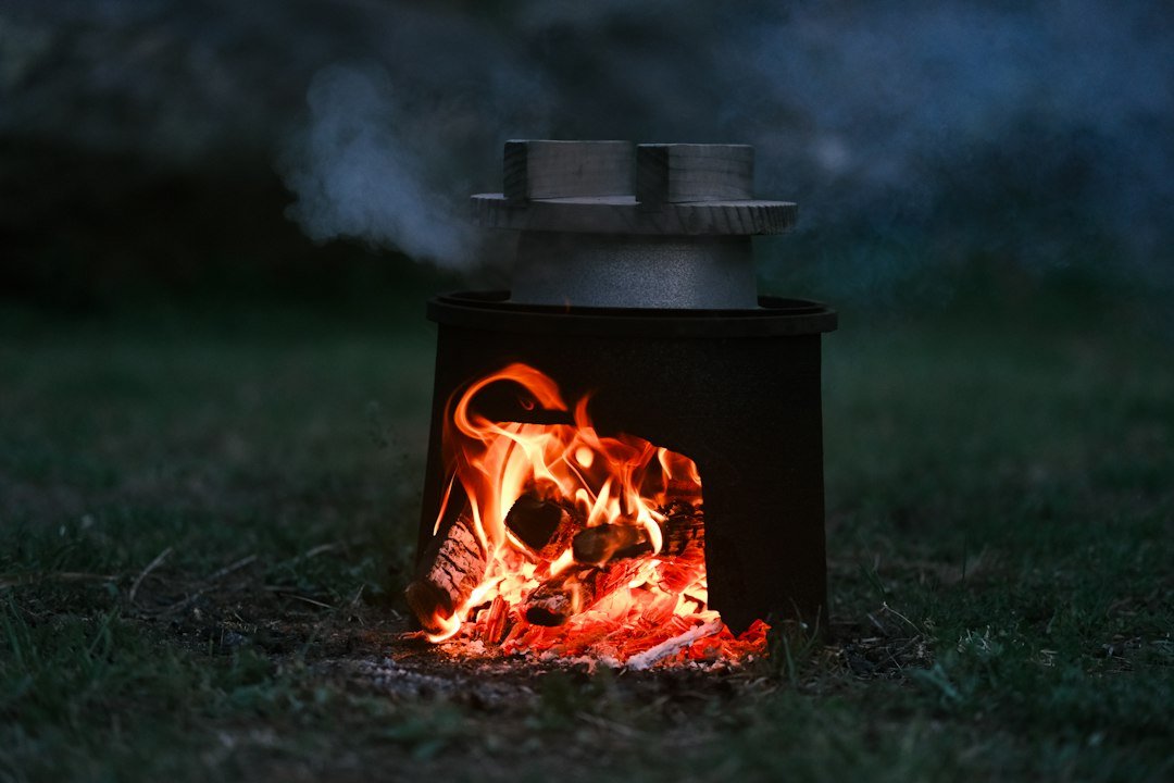 Outdoor stove with burning wood and pot